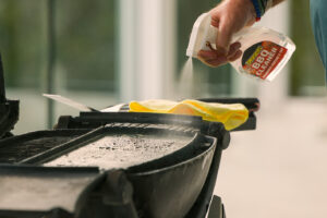 Spraying BBQ Cleaner on Dirty BBQ